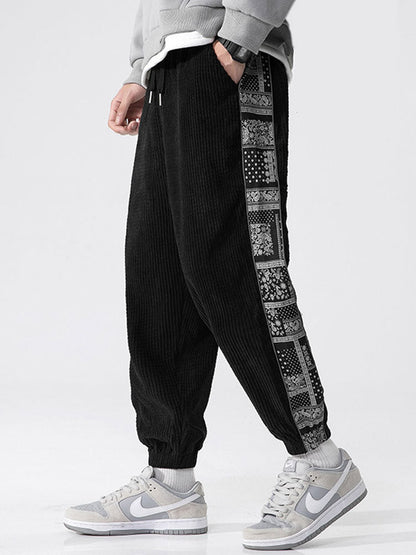 Calça de veludo cotelê com painéis estampados de paisley