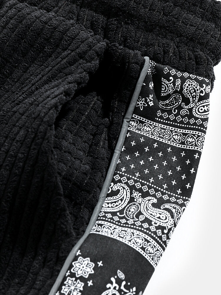 Calça de veludo cotelê com painéis estampados de paisley